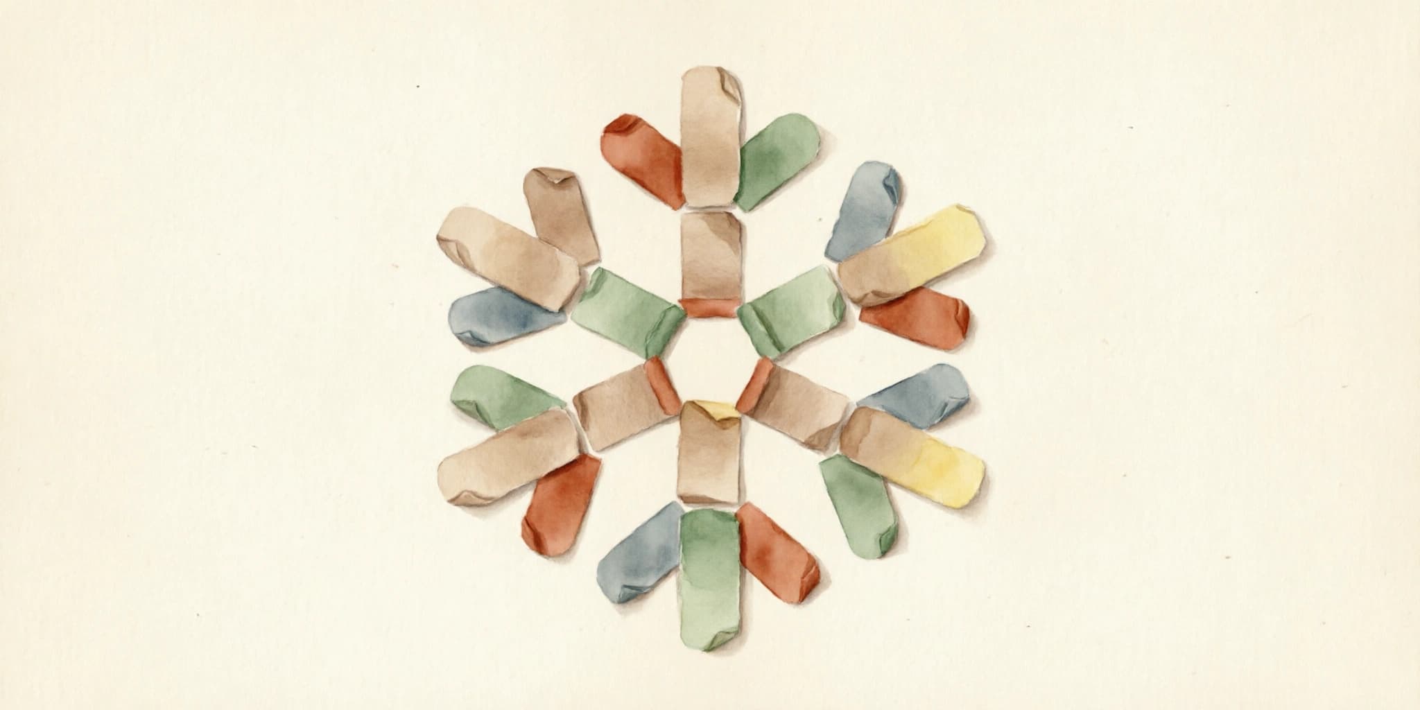 A six-pointed snowflake shape assembled from small paper index cards on a writing desk, sparse at the center and growing more intricate toward the edges